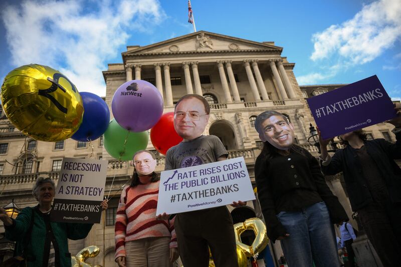 Protesters wearing masks of Britain's Prime Minister Rishi Sunak and Bank of England Governor Andrew Bailey during a protest outside the Bank Of England in the City of London. AFP