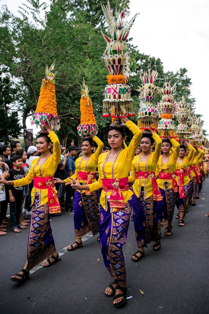 Balinese take part in a parade to mark the opening of the annual Bali Art Festival on a main road in Denpasar, Bali, Indonesia. Made Nagi / EPA