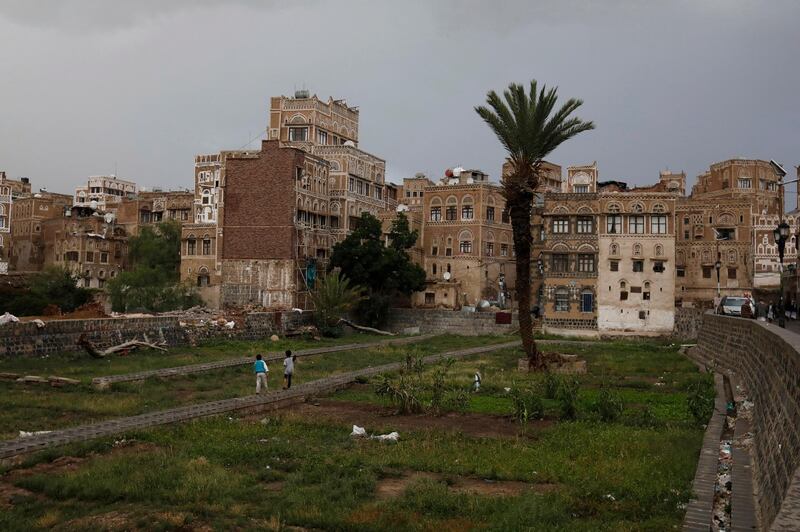 Yemeni children walk past historic buildings in the old quarter of Sanaa, Yemen.  EPA
