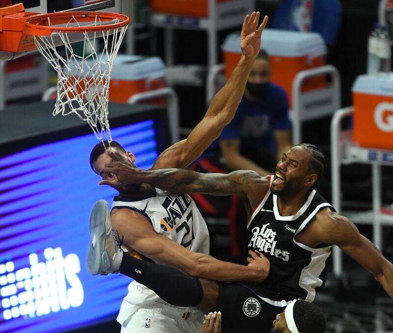 Feb 19, 2021; Los Angeles, California, USA;  Los Angeles Clippers forward Kawhi Leonard (2) is charged with an offensive foul as he goes up for a dunk over Utah Jazz center Rudy Gobert (27) in the second half of the game at Staples Center. Mandatory Credit: Jayne Kamin-Oncea-USA TODAY Sports