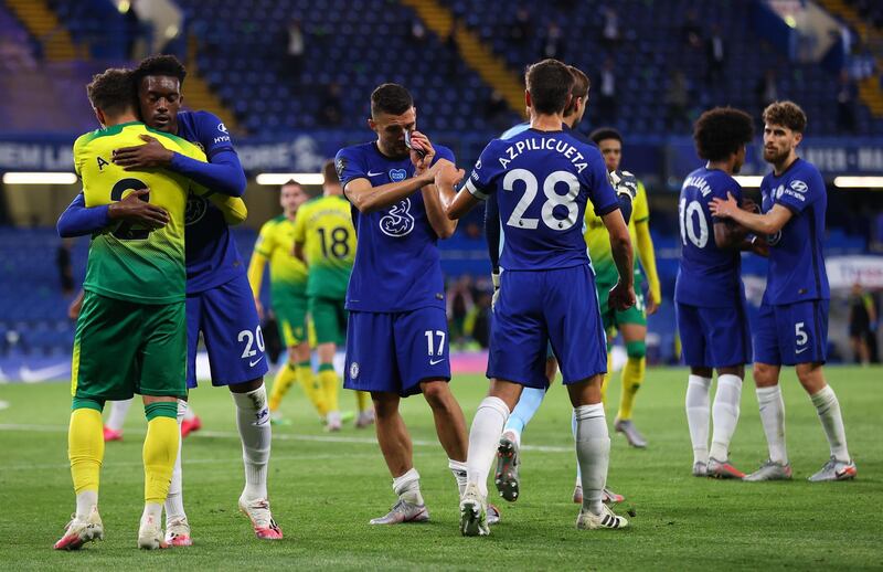 LONDON, ENGLAND - JULY 14:  Tammy Abraham of Chelsea hugs Max Aarons of Norwich City at the final whistle during the Premier League match between Chelsea FC and Norwich City at Stamford Bridge on July 14, 2020 in London, England. Football Stadiums around Europe remain empty due to the Coronavirus Pandemic as Government social distancing laws prohibit fans inside venues resulting in all fixtures being played behind closed doors. (Photo by Julian Finney/Getty Images)