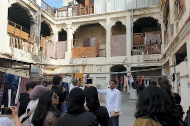 Bahraini architect Ali Karimi shows a group of onlookers an old school in Manama as part of a new series of tours taking in Bahrain's architecture. Nawal Abulkarim