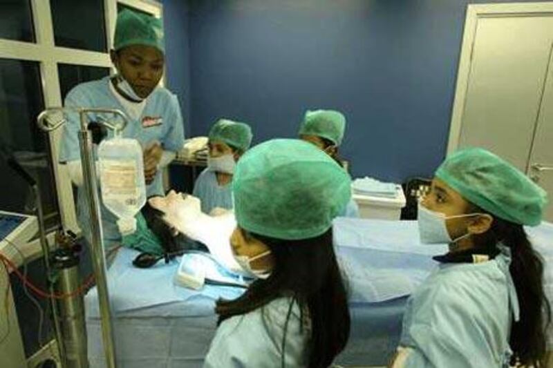 Children play the role of doctors at the KidZania educational theme park at the Dubai Mall.