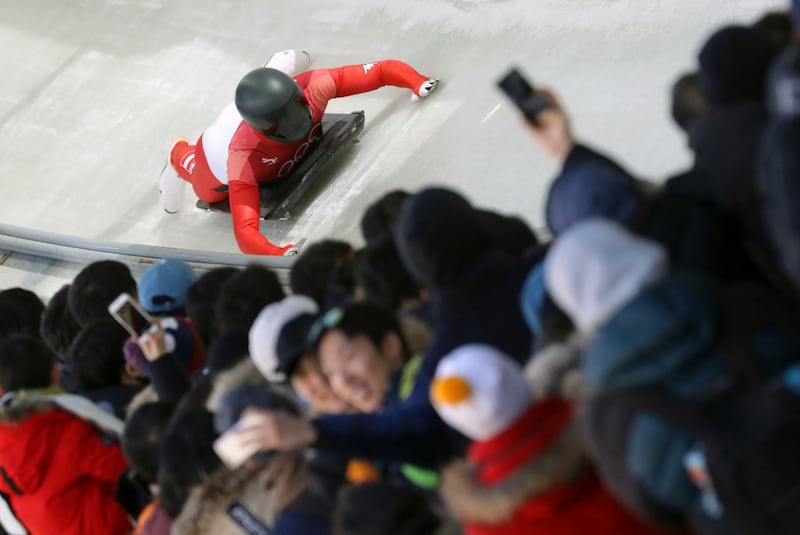 Matthias Guggenberger of Austria brakes in the finish area during the men's skeleton competition at the 2018 Winter Olympics. Michael Sohn / AP Photo