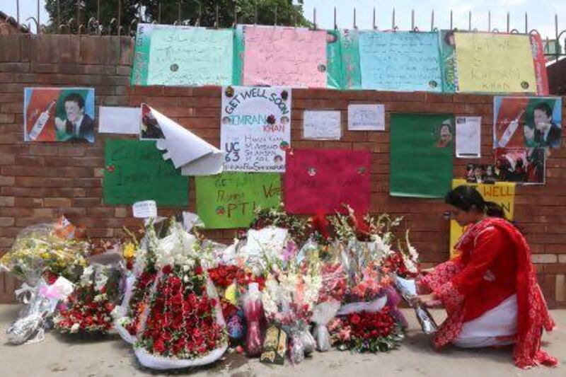 A supporter of Pakistani cricketer-turned-politician Imran Khan lays a floral wreath outside the Shaukat Khanum hospital in Lahore.