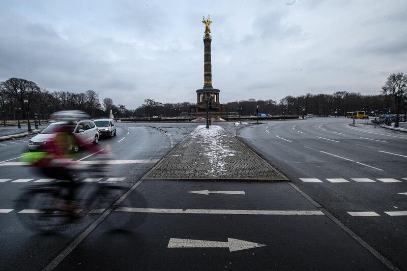 A cyclist crosses the nearly empty streets at the Victory Column in Berlin, Germany.  EPA