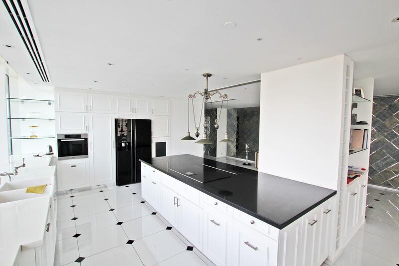 The kitchen has a black and white colour scheme throughout. Courtesy Allsopp & Allsopp
