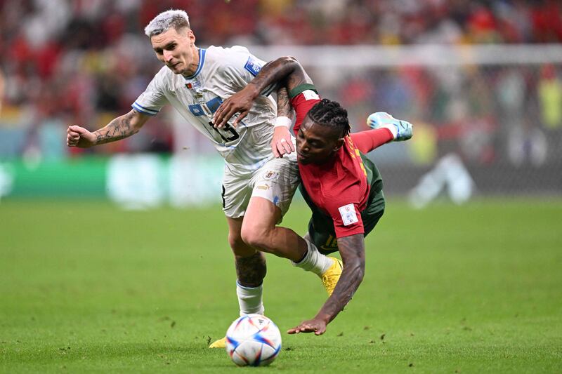 Uruguay's defender Guillermo Varela fights for the ball with Portugal's Rafael Leao. AFP