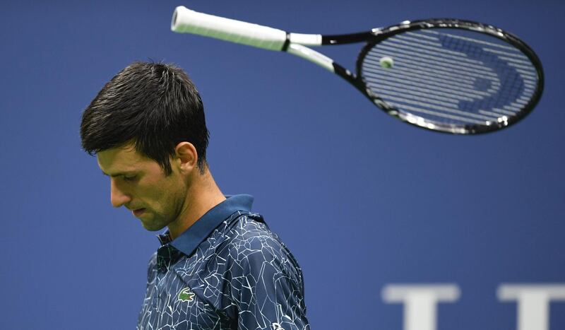 Novak Djokovic tosses his racket while playing against Tennys Sandgren during their 2018 US Open men's round two match in New York.  AFP