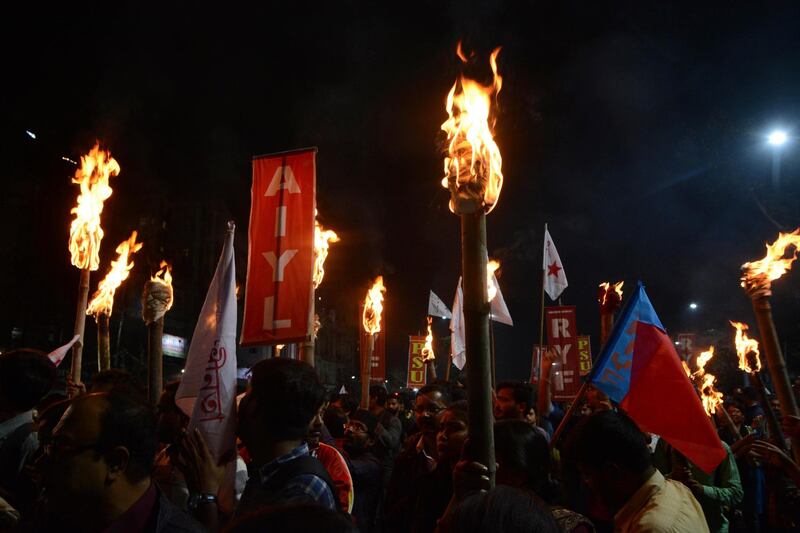 Activists of left student organizations light torches during a protest against a new citizenship law in Kolkata, India. AP Photo