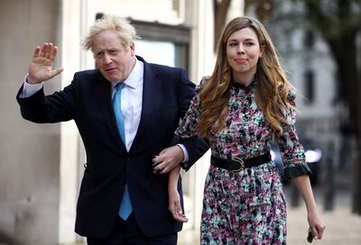 Britain's Prime Minister Boris Johnson and partner Carrie Symonds arrive at a Westminster polling station to vote, in London, Britain May 6, 2021. REUTERS/Henry Nicholls