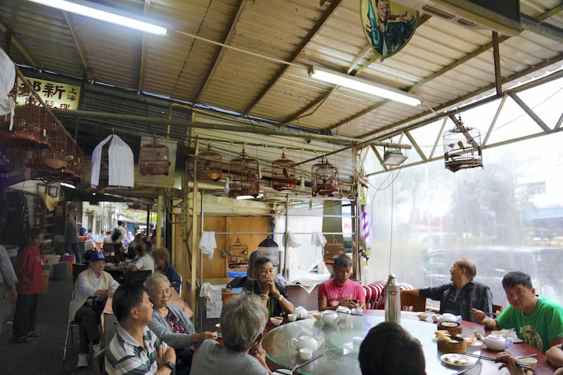 Patrons share the day's news at Xin Long Cheng cafe. Peter Yeung for The National