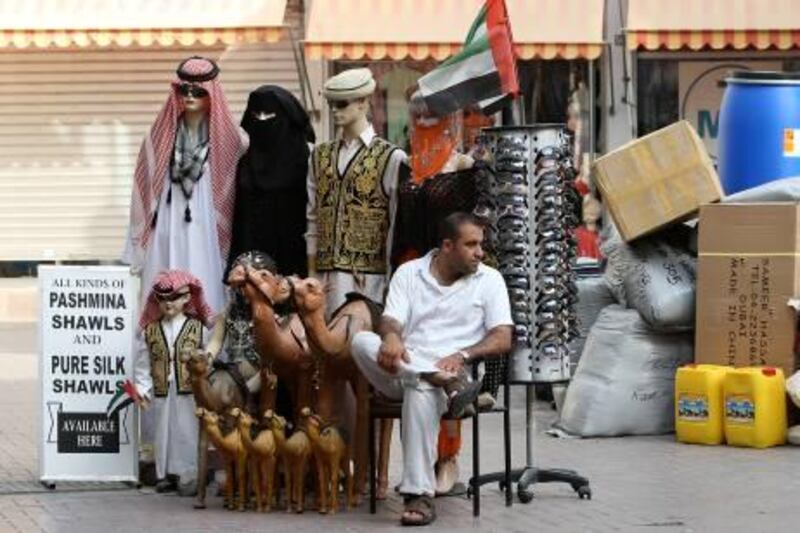 DUBAI, UNITED ARAB EMIRATES Ð July 13: One of the shopkeeper sitting outside his shop at Gold Souk in Deira, Dubai. (Pawan Singh / The National) *** Local Caption ***  PS01- SHOP.jpg