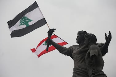 Two Lebanese flags in Martyrs' Square, in downtown Beirut near the port explosion, which has exacerbated the economic woes of the country. EPA