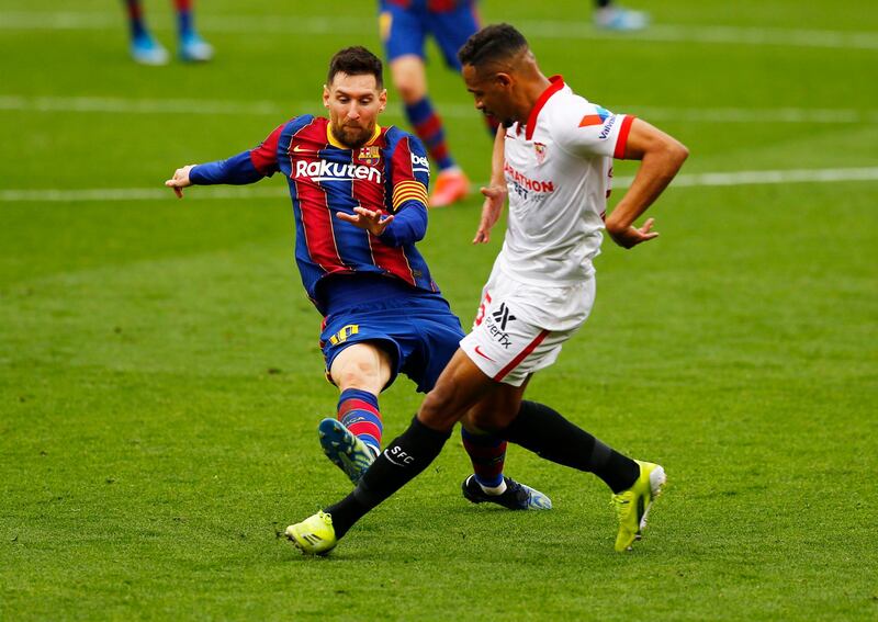 Barcelona attacker Lionel Messi was booked for this tackle on Sevilla's Fernando. Reuters