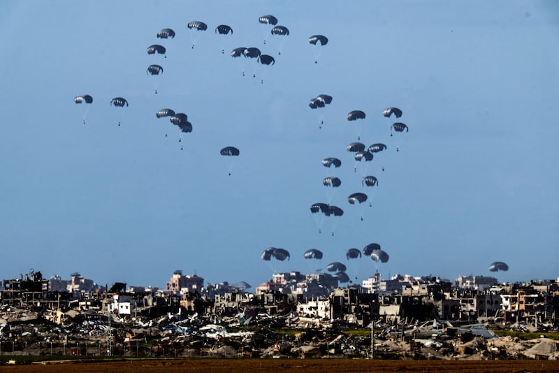 Aid packages are dropped into northern Gaza from a military aircraft. Reuters