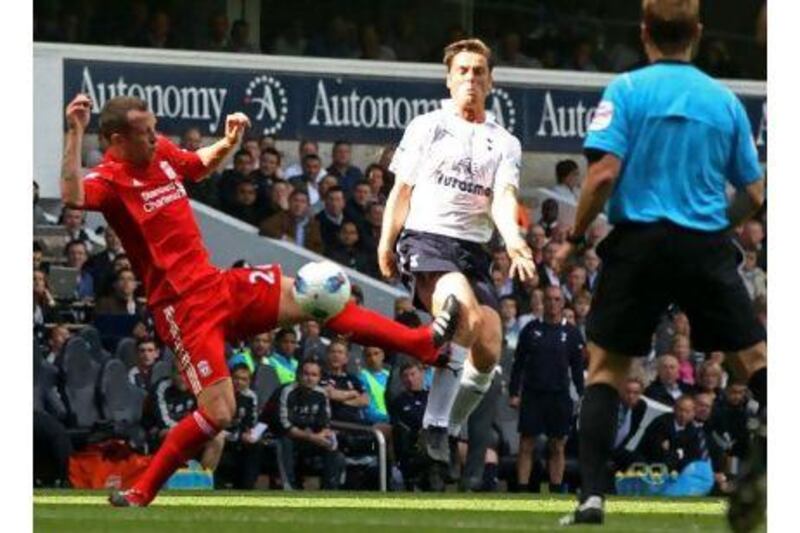 Liverpool's Charlie Adam, left, earns his second booking yesterday with a knee-high tackle on Tottenham Hotspur's Scott Parker. Adrian Dennis / AFP