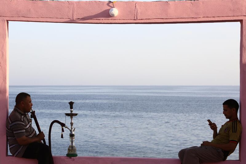 Two men sit on wall overlooking the Red Sea at a popular cafe in the northwestern Saudi town of al-Wajh on April 25, 2016. / AFP PHOTO / MOHAMMED ALHWAITY / “The erroneous mentions appearing in the metadata of this photo by MOHAMMED ALHWAITI has been modified in AFP systems in the following manner: [MOHAMED ALHWAITY ] instead of [MOHAMMED AL-BUHAISI]. Please immediately remove the erroneous mentions from all your online services and delete it (them) from your servers. If you have been authorized by AFP to distribute it to third parties, please ensure that the same actions are carried out by them. Failure to promptly comply with these instructions will entail liability on your part for any continued or post notification usage. Therefore we thank you very much for all your attention and prompt action. We are sorry for the inconvenience this notification may cause and remain at your disposal for any further information you may require.”