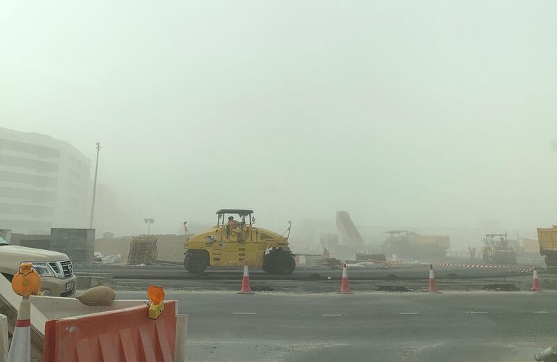 DUBAI, UNITED ARAB EMIRATES , Feb 26  – 2020 :- Construction workers during the sandstorm in Dubai Investment Park area in Dubai. (Pawan Singh / The National) For News/Online/Instagram.  
