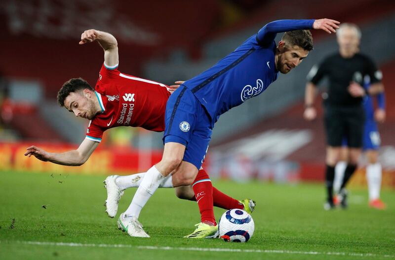 Liverpool's Ozan Kabak, left, challenges for the ball with Chelsea's Jorginho. AP