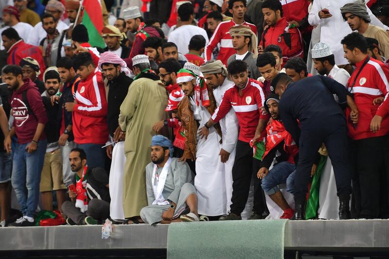 Omani fans stand behind a broken glass barrier at the end of the Gulf Cup of Nations 2017 final football match between Oman and the UAE at the Sheikh Jaber al-Ahmad Stadium in Kuwait City on January 5, 2018. Guiseppe Cacace / AFP