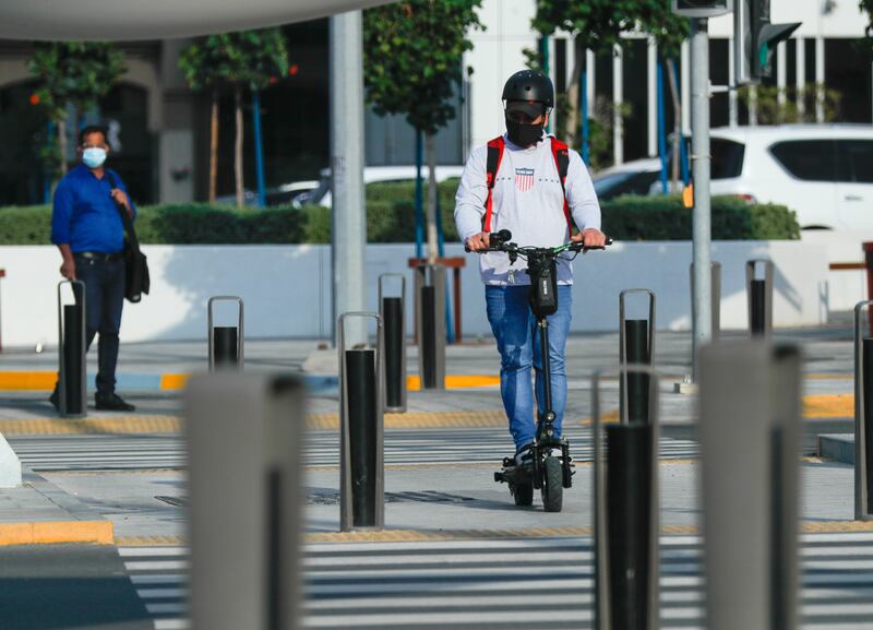 The campaign calls on people to ride the electric vehicles on designated paths and wear helmets, knee pads and reflective clothes, especially at night.  Victor Besa / The National