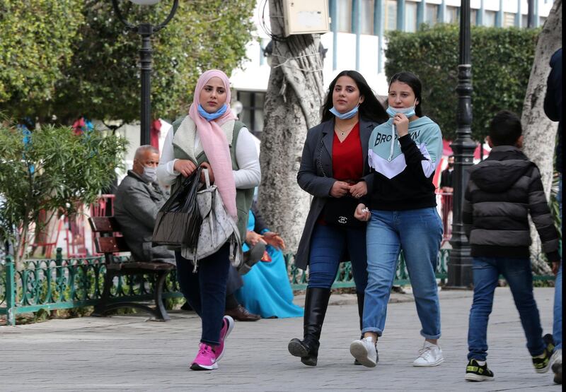epa08958071 Tunisian women walk on Habib Bourguiba avenue in Tunis, Tunisia, 22 January 2021. Tunisian Minister of Health Faouzi Mahdi said on 22 January his country recorded the day before 100 deaths caused by the Coronavirus, the heaviest death toll since the start of the pandemic.  EPA/MOHAMED MESSARA