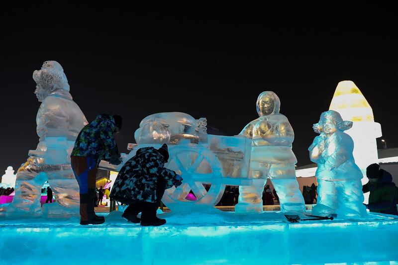 Chinese workers makes an ice sculpture during the Harbin Ice and snow world in Harbin, Heilongjiang Province, China. Getty Images
