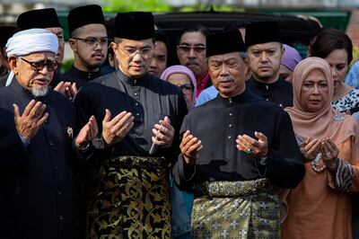 KUALA LUMPUR, MALAYSIA - MARCH 01: Muhyiddin Yassin, Malaysia's newly appointed Prime Minister prays outside his house with his family and supporters before departing for the swearing in ceremony at the palace on March 1, 2020 in Kuala Lumpur, Malaysia. (Photo by Ore Huiying/Getty Images)