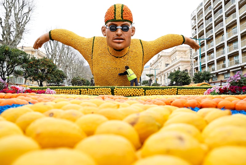 A man works on a sculpture of lemons and oranges for the 90th Lemon Festival in the French Riviera town of Menton, which runs from February 17 to March 3. EPA