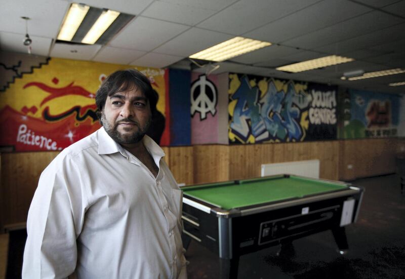 Hanif Qadir, a former extremist who now runs the Active Change Foundation, a de-radicalization project in London which works with young people at risk of embracing terrorism and people convicted of terrorists offenses, stands at the foundation's youth centre, in east London, Monday, May 23, 2011. In Britain, a controversial government project involving police and educators has identified 1,000 people, most aged under 25 but some as young as 7-years-old, as vulnerable to the appeal of extremism _ many of whom reguarly browse jihadist videos or websites. Youngsters swap imported extremists DVDs and clips of beheadings stored on their cellphones, and use SMS messages or Twitter to trade addresses for jihdaist websites, Qadir said.(AP Photo/Lefteris Pitarakis) 