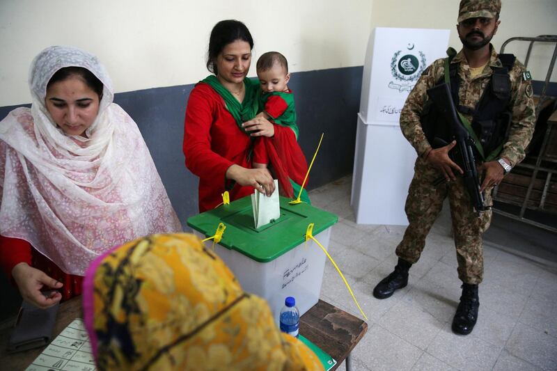 Voters cast their votes at a polling station during general election in Islamabad. Reuters