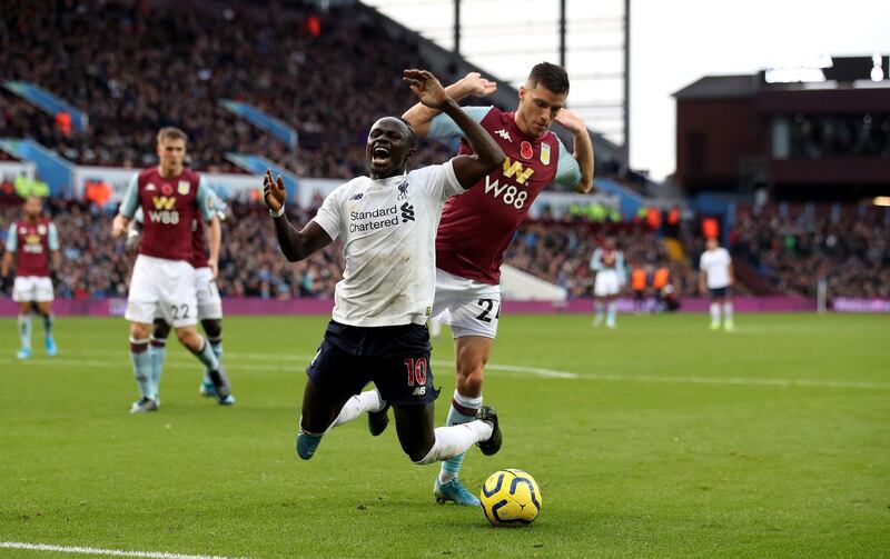 Liverpool's Sadio Mane goes down in the area after a challenge from Aston Villa's Frederic Guilbert at Villa Park. PA