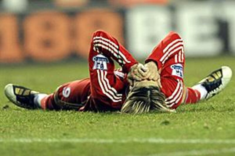 Floored: Fernando Torres will be out for around six weeks after knee surgery.