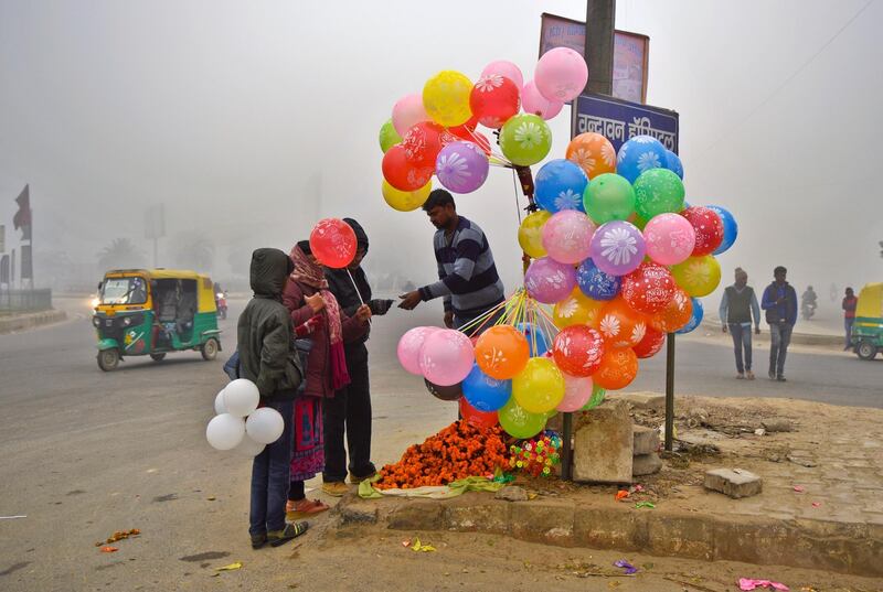 A man sells balloons at a traffic roundabout in Greater Noida, outskirts of New Delhi, India. RS Iyer / AP Photo