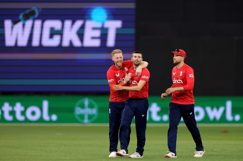 Mark Wood  is congratulated by Ben Stokes after dismissing David Warner for 73. EPA