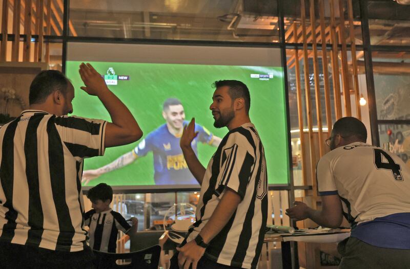 Saudi fans of English football club Newcastle United celebrate a goal against Premier League rivals Tottenham Hotspur, at a Riyadh cafe. AFP