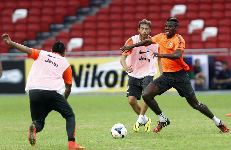 Juventus player Paul Pogba, right, trains with teammates ahead of their match against a Singapore XI in the Far East. Edgar Su/ Reuters

