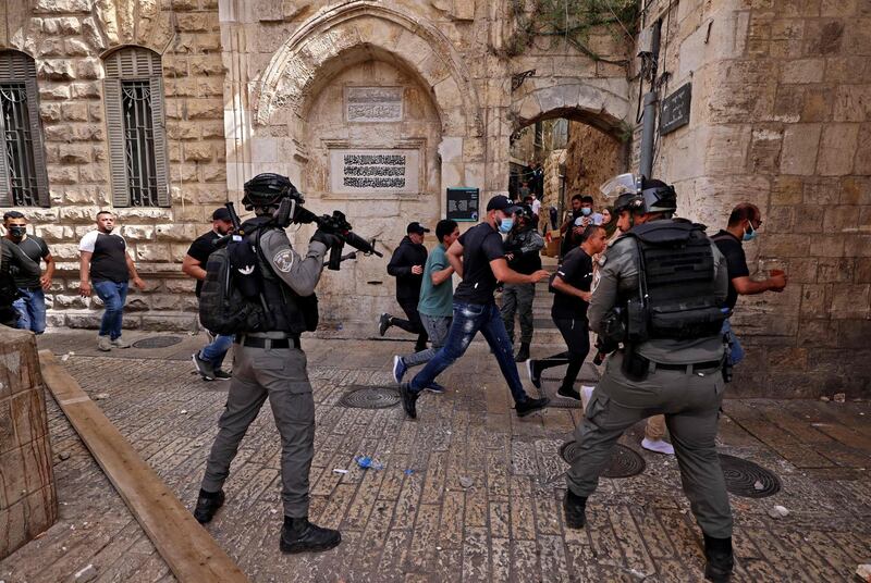 Palestinian protesters flee attack by Israeli security forces in Jerusalem's Old City on May 10, 2021. AFP