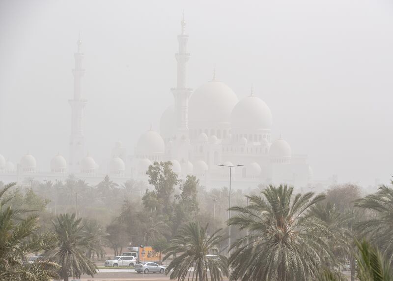 Sheikh Zayed Grand Mosque is obscured by a haze of sand and dust in Abu Dhabi. Winds have reached 40 kilometres an hour in the capital. Victor Besa / The National