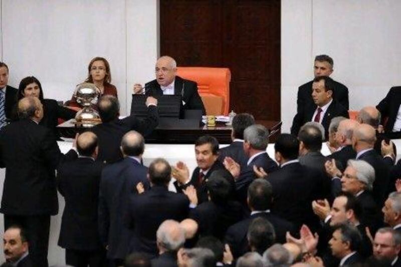 Politicians and the parliament's speaker, Cemil Cicek, rear centre, argue at the parliament in Ankara in February this year. A lack of consensus over the wording of the new constitution suggests more volatility is likely in parliament today, and that whatever is produced may be a stop-gap document.