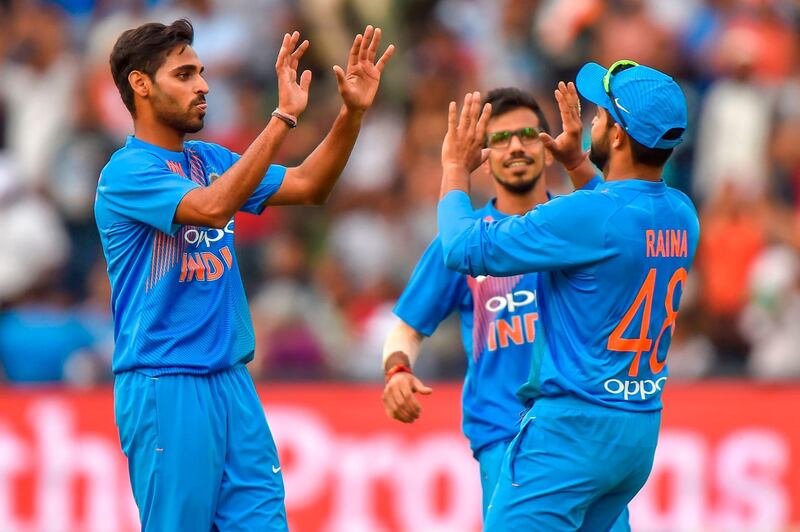  India's Suresh Raina (R) celebrates with teammate Bhuvneshwar Kumar (L) after taking a catch to dismiss unseen South African batsman Chris Morris during the first T20I cricket match between South Africa and India at The Wanderers Cricket Stadium in Johannesburg on February 18, 2018.  / AFP PHOTO / Christiaan Kotze