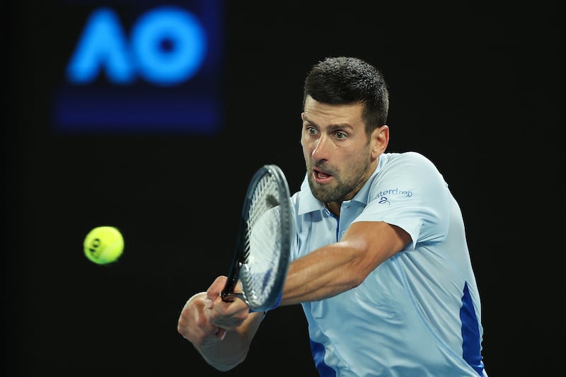 Novak Djokovic plays a backhand to Adrian Mannarino during their fourth-round match at the 2024 Australian Open at Melbourne Park on January 21, 2024 in Melbourne, Australia. Getty Images