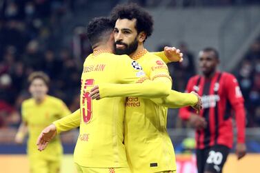 Liverpool's Mohamed Salah celebrates scoring the equalizer with his teammate Alex Oxlade-Chamberlain (L) during the UEFA Champions League group B soccer match between Ac Milan and Liverpool at Giuseppe Meazza stadium in Milan, Italy, 07 December 2021.   EPA / MATTEO BAZZI