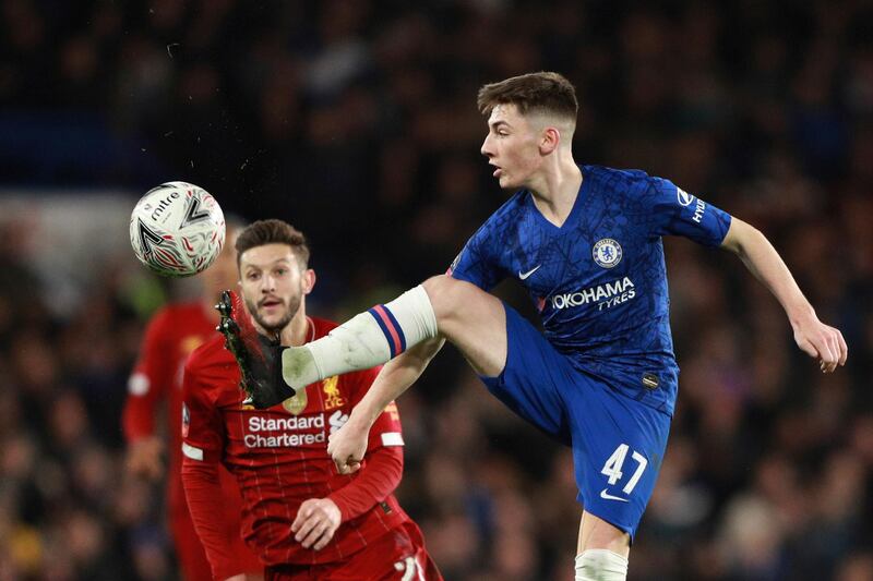 Billy Gilmour, right, controls the ball in front of Liverpool midfielder Adam Lallana AP Photo