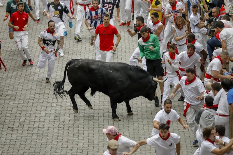 A reveller is tossed by a Puerto de San Lorenzo's fighting bull before entering the bullring during the second day of the San Fermin Running of the Bulls festival on  in Pamplona, Spain.  Getty Images