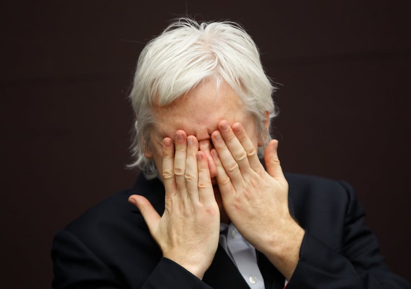 He covers his eyes during a news conference in central London, in December 2011. AP Photo
