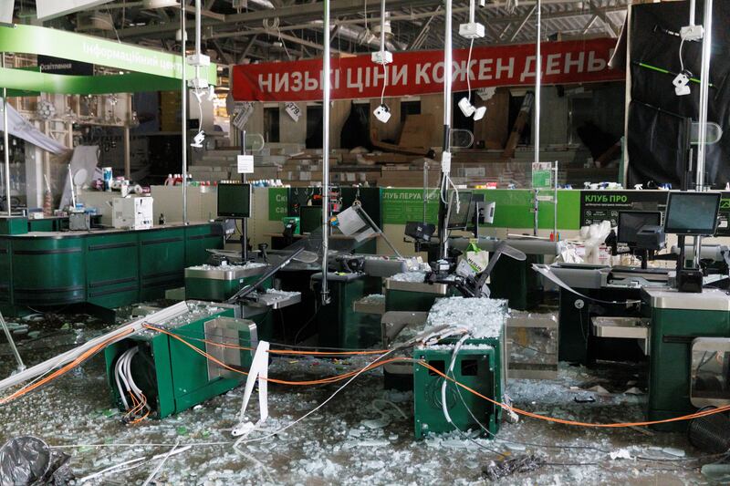 Checkout tills are damaged at a supermarket in a shopping centre that was damaged in a bombing in Kyiv. Reuters