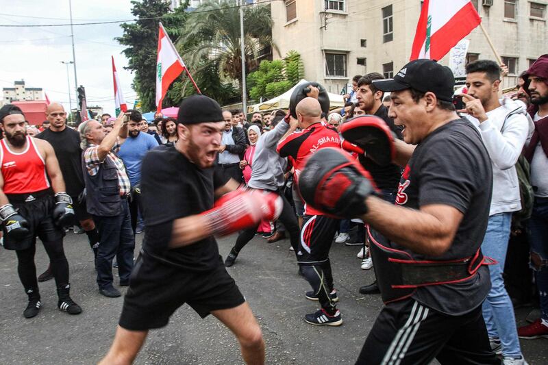 Lebanese boxers perform before people gathering during a demonstration in the southern city of Sidon. AFP