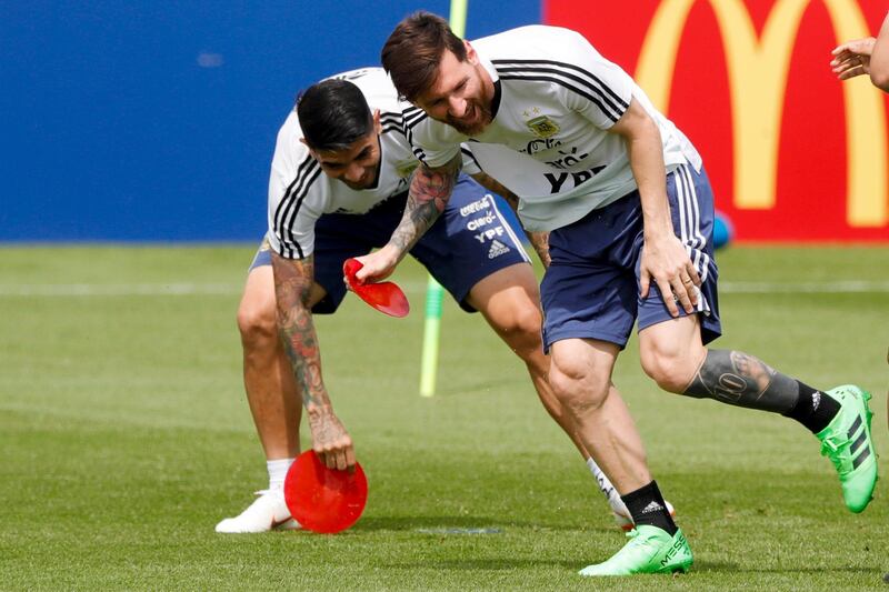 Lionel Messi collects field markers during a training session. Ricardo Mazalan / AP Photo